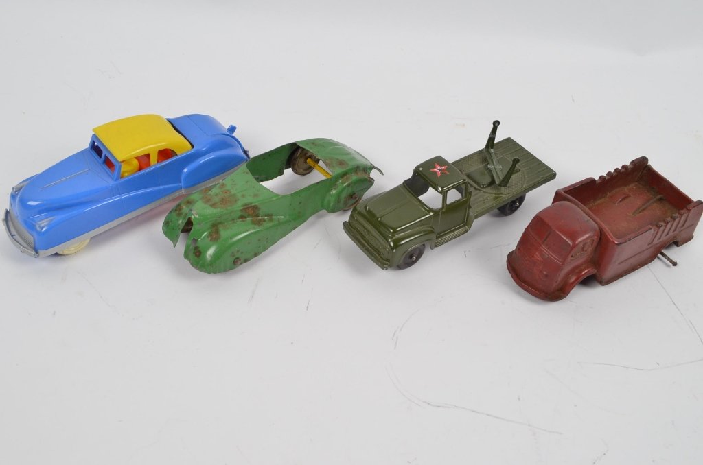 (4) Vintage Children's Toy Cars: A red Auburn Rubber toy truck with no wheels. A tootsie toy US Army truck. A green cast metal car and a plastic toy car with yellow convertible roof. 4 vintage toy cars.