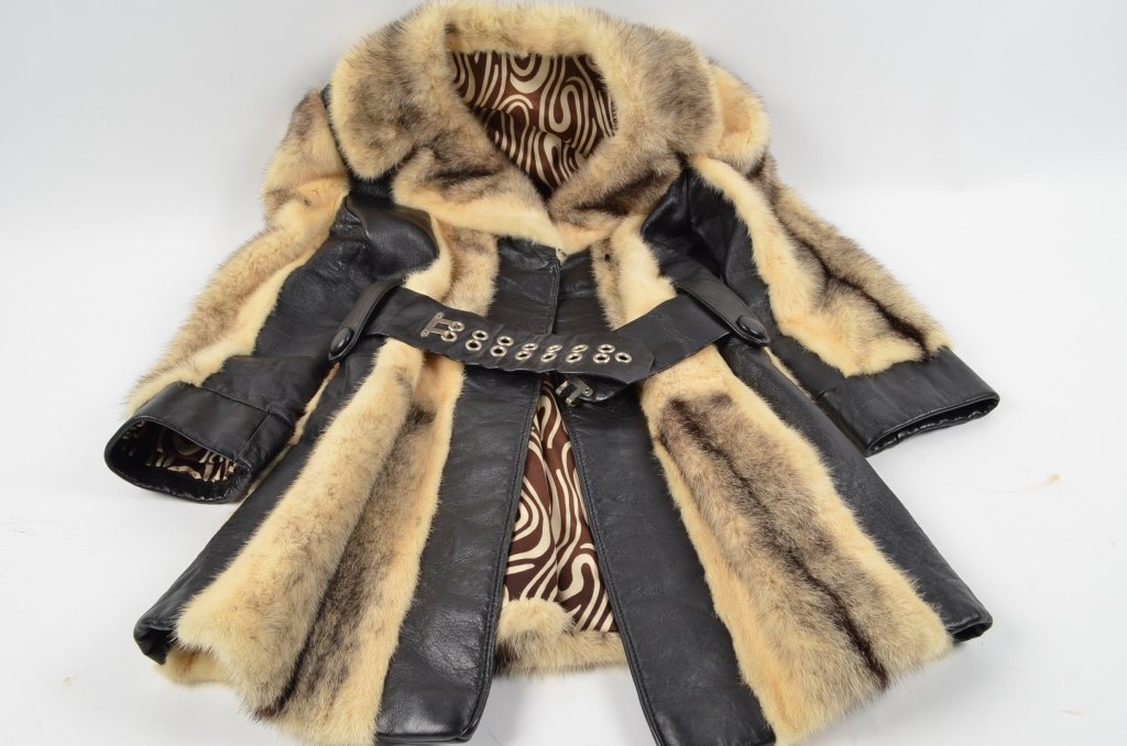 Ladies Fishman's Fur Coat: A white and black fur coat with black leather cuffs and accents. Sleeves measure 14" from the end of the cuff to the pit of the arm. The coat measures 16" on the back from shoulder seam to shoulder se