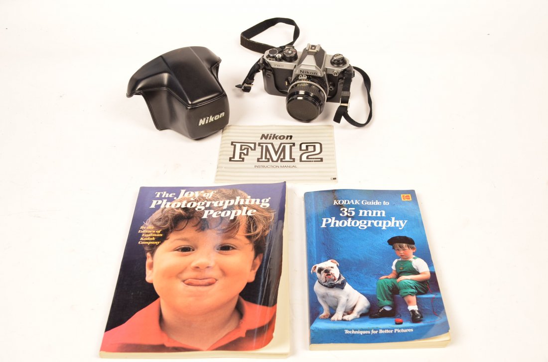 Nikon FM2 Camera 35mm Lens & Photography Books: This lot is for a 35mm single lens reflux focal plane shutter camera. Camera has film advance and shutter speed settings and comes with camera case and instructional manual. You are also getting "Koda