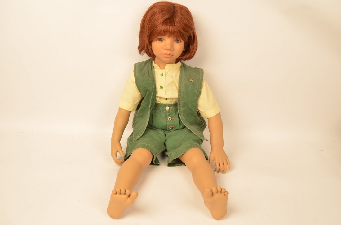 Annette Himstedt Melvin Collectible Doll: Auburn hair with blue eyes and freckled face. Dressed in his original green corduroy short set with button down shirt. Marked on neck, back of legs and arms. Boy doll is vinyl with Polyester Fiberfill
