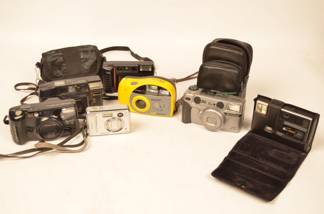 Lot of Misc. Cameras: Fuji Panorama 320 Zoom film camera with zoom lens 38-120mm. Vivitar A35 Splash Proof camera. Fuji DL-400 Tele compact camera with instruction manual. Fuji Discovery 1000 Zoom camera. Ansco 735 camera.