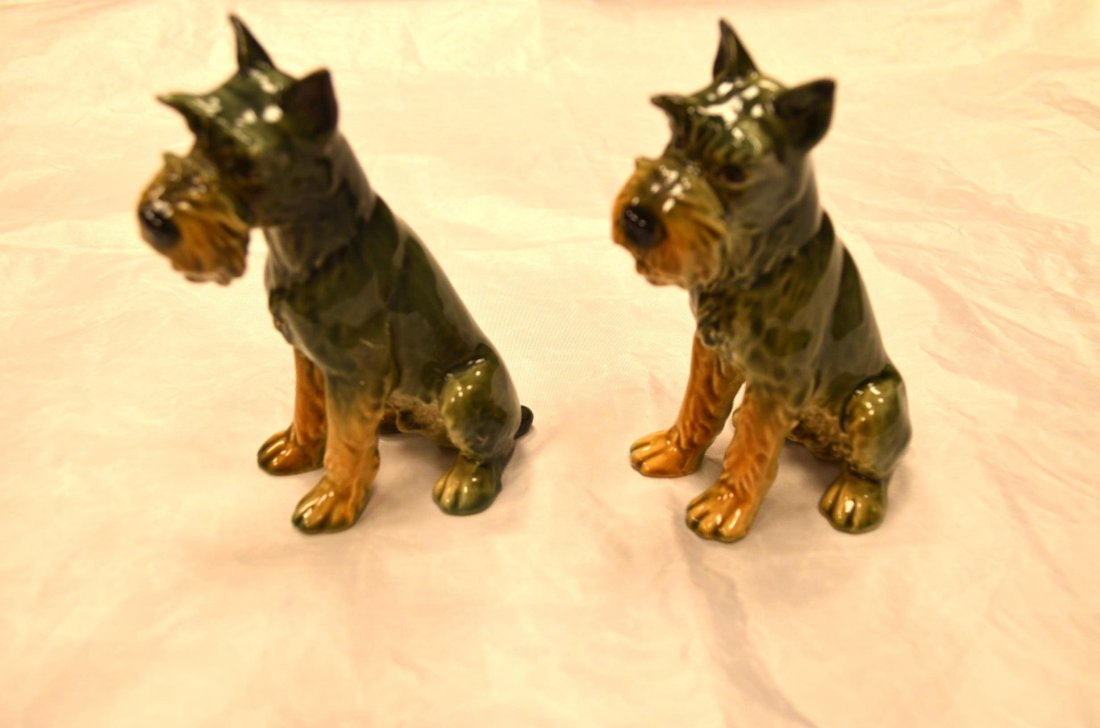 Pair of Goebel Scottie Dog Figurines: Pair of identical matching scottie dog porcelain figurines by Goebel. Made in West Germany. Measure approximately 5" tall. Green dog figurines.