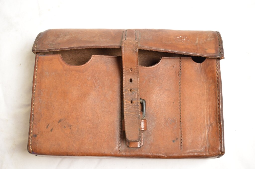 Simmons Hardware Leather Ammo Pouch: Simmons Hardware leather ammo pouch. Single buckle on the front, looks like shoulder strap, and belt loop on the back. Looks like it was made to hold gun magazines of assorted sizes. Nice leather stit