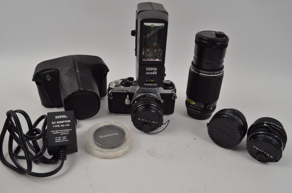 Pentax Camera & Lenses: Contact Pak Mail (260) 637-4809 for shipping quote prior to bidding. Offered is a Pentax ME Super camera and a Sunpak auto 411 flash. Also included is a SMC Pentax-M 1:4,5 80mm - 200mm lens. A Vivitar