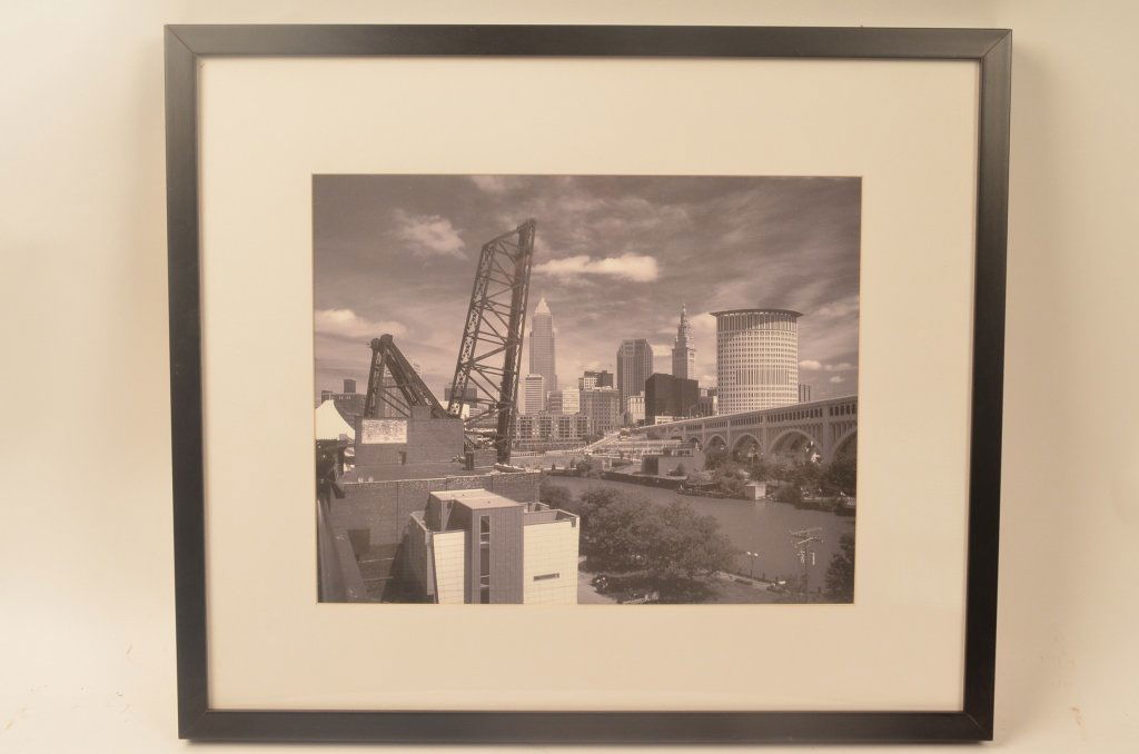 Robert Pence Cleveland Skyline Photo: Contact Pak Mail (260) 637-4809 for shipping quote prior to bidding. Offered is a framed black and white photograph of the Cleveland skyline by Robert Pence. Framed photo has an overall measurement of