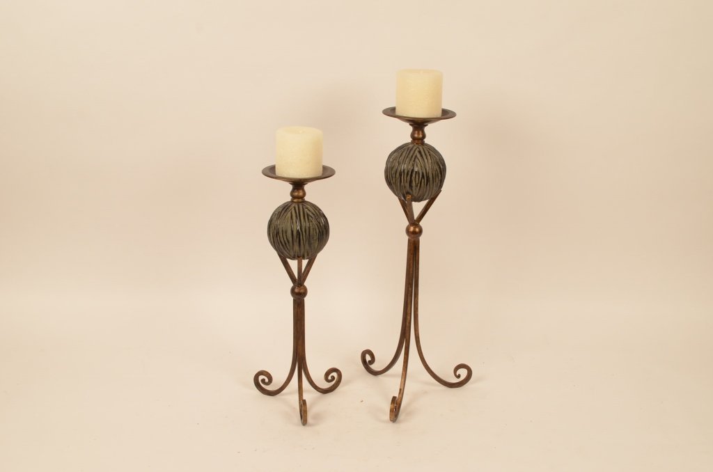 Pair of Contemporary Candle Holders: Modern floor candle pillars have 3 legged bases. Comes furnished with two never used candles. Metal construction, stands 20.75" and 17" tall.