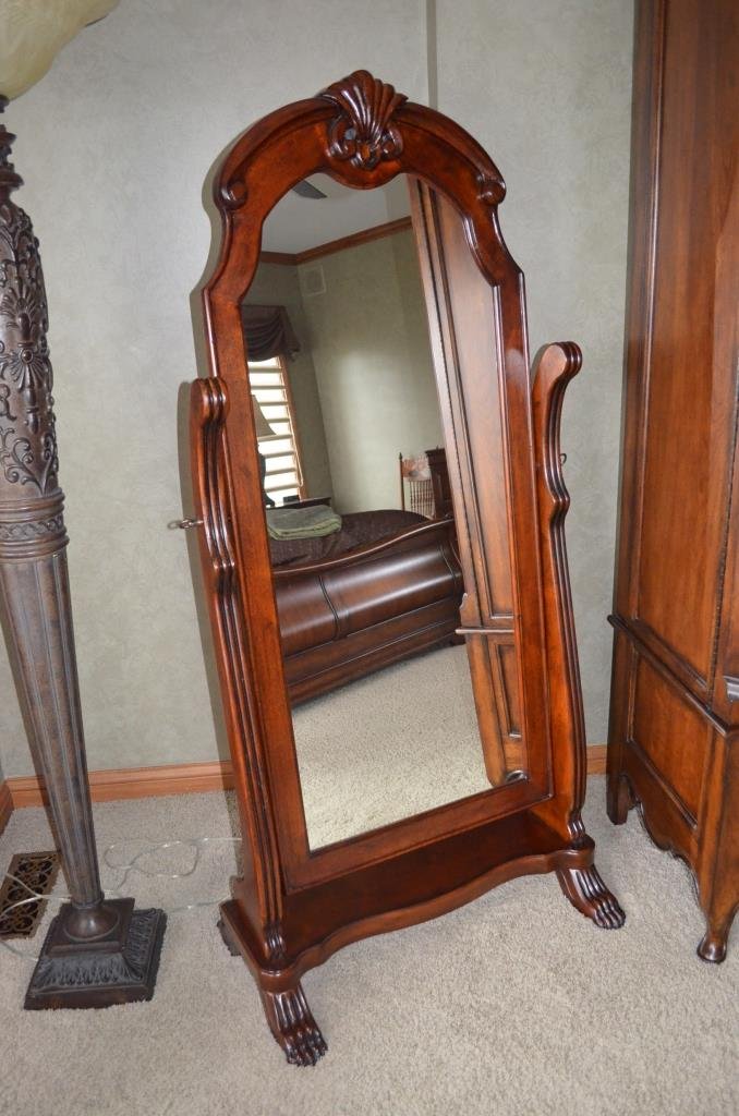 Large Full Length Dressing Mirror: Vanity mirror has a dark wood finish, claw feet and swivel mirror. Plantation Cherry collection by Butler Brothers Company. Measures 67' H X 30" W X 20.5" D.