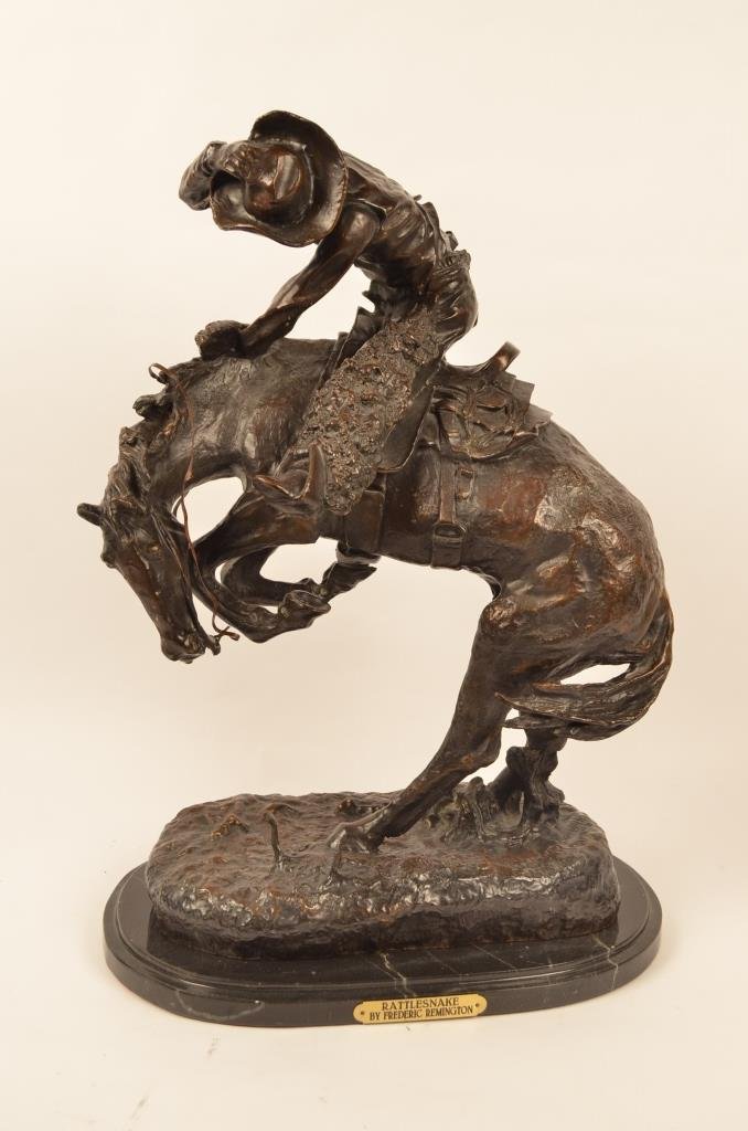 "Rattlesnake" Bronze Statue Frederic C. Remington: Contact Pak Mail (260) 637-4809 for shipping quote prior to bidding. A large bronze statue of cowboy on a bucking bronco sculpted by Frederic Remington. Statue measures 23" tall.