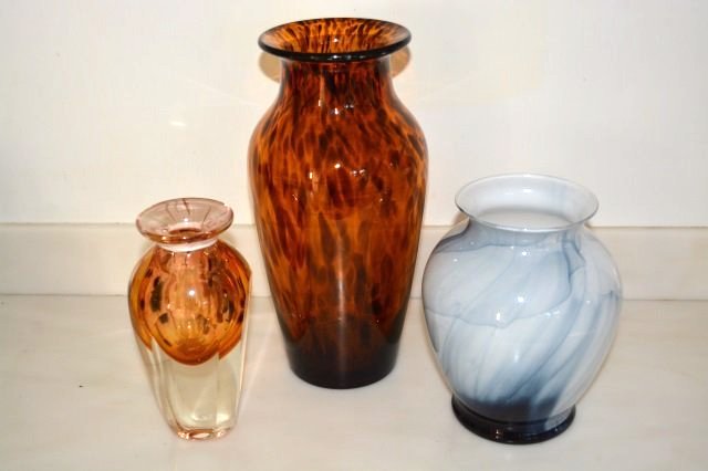 (3) Art Glass Vases: (3) Art glass vases. Larger vase, tortoise shell pattern, amber w/ brown spots, is hand blown, pontil on bottom, 12"H. The smaller vase is 7.5"H. Blue & white swirl vase, 7.5" H. Contact our recommend