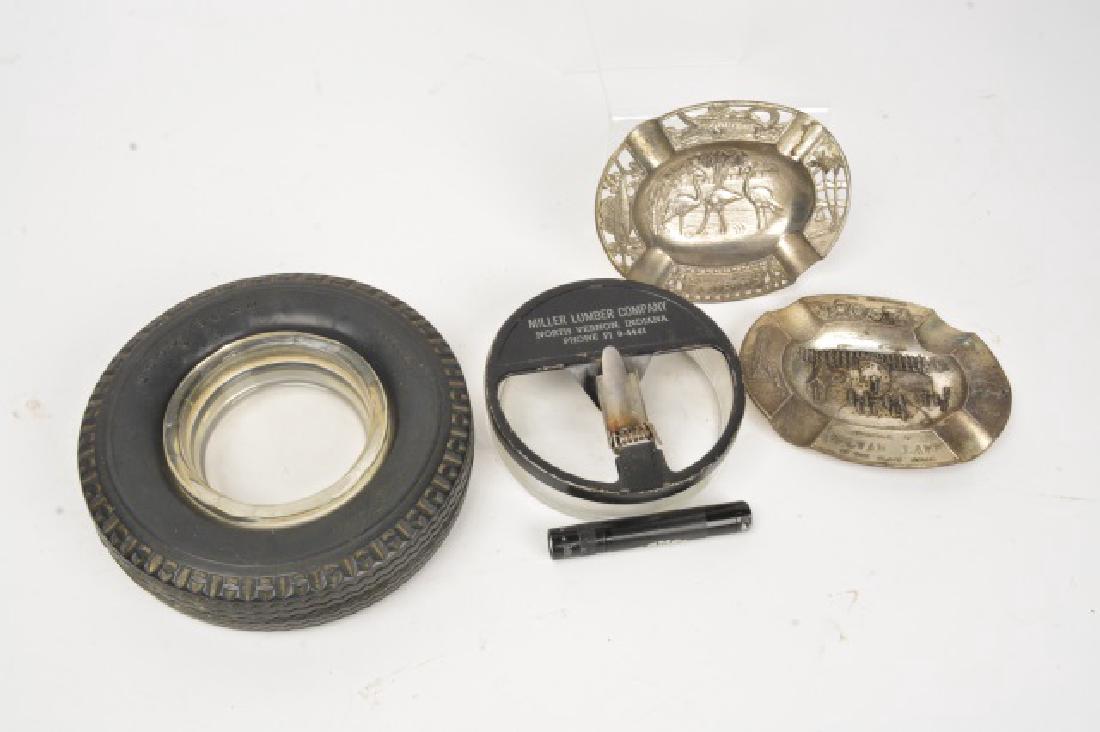 Tobacciana & Beer Adv. Ashtrays & Collectibles: (4) Advertising ashtrays, (1) Camel cigarettes advertising pocket flashlight. Goodyear tire ashtray 6" diameter. Miller Lumber Company (North Vernon, Indiana) ashtray. Florida souvenir tin ashtray emb