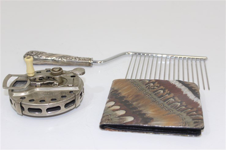 Misc Lot Wallet, Spinng Reel, Cake Cutter: wallet is made with real bird feathers, vintage waltonian spinning reel made by square stamping company, cake cutter features a STERLING SILVER handle. approx 11" long