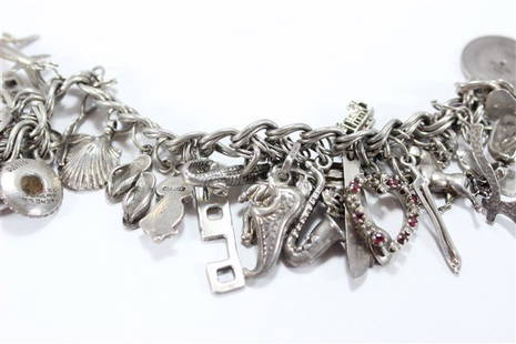 Sterling Silver Vintage Charm Bracelet: 56.9 grams, approx. 25 sterling charms.