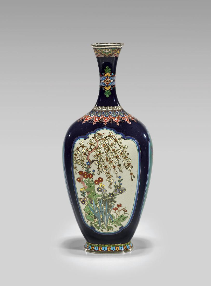 ANTIQUE JAPANESE CLOISONNÉ ENAMEL VASE: Antique Japanese cloisonné enamel vase; squared ovoid form with slender neck and splayed foot; with panels of flowering wisteria and prunus on soft green grounds to the front and verso; the sid