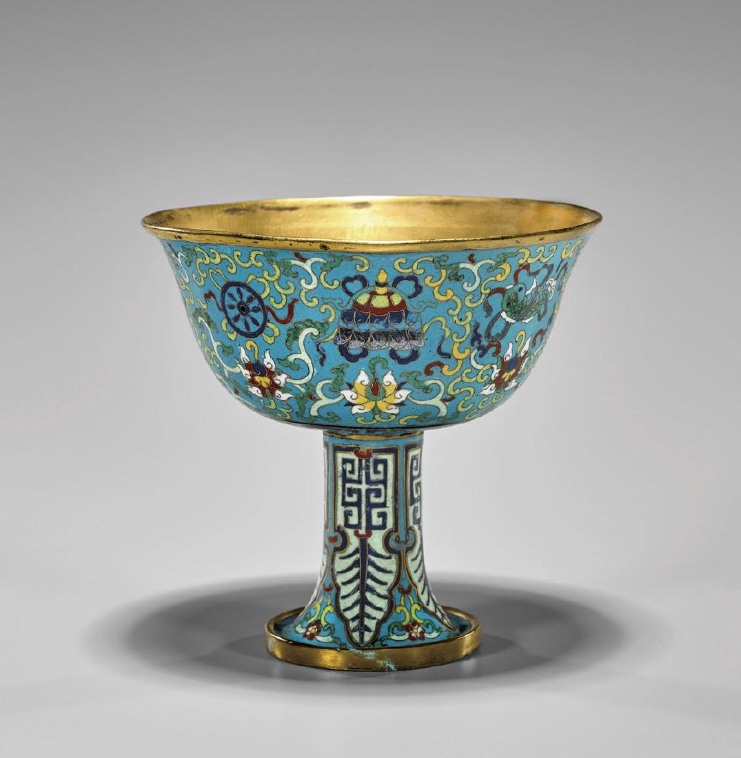 QIANLONG-STYLE CLOISONNÉ STEM BOWL: Chinese Qianlong-style, cloisonné enamel stem bowl; the wide flared bowl set on a slim waisted support on a splayed foot; with deign of the Eight Buddhist emblems amid scrolling lotus reserved 