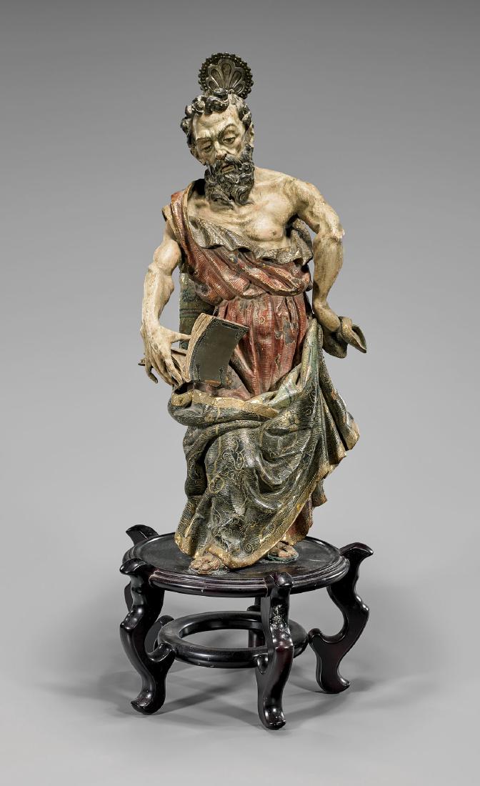 ANTIQUE SPANISH BAROQUE POLYCHROMED WOOD FIGURE: Antique Spanish Baroque polychromed wood standing figure; the bearded saint in elaborate estofado gilt patterned robe, holding out an open book, and showing good musculature; Provenance: From the Coll
