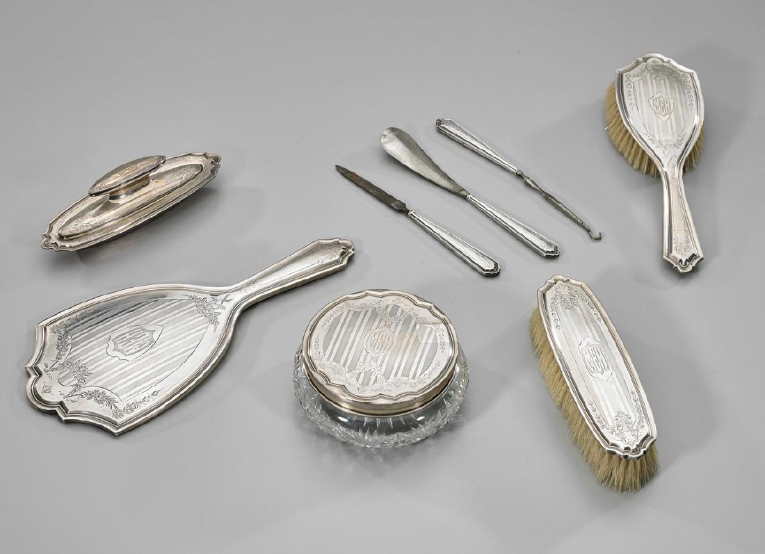 Eight-Piece Sterling Silver Vanity Set: Eight-piece sterling silver vanity set, including: cut glass soap dish; hand mirror; hair brush; garment brush; shoe horn; nail file; handled nail buffer with lid; together with cuticle tool; several