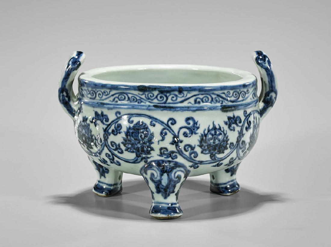 Xuande-Style Blue & White Porcelain Censer: Chinese Ming-style blue and white porcelain tripod censer; of squat form, with moulded loop handles; Buddhist emblems among swirling design to body; four-character Xuande mark to base, but later; D: 6