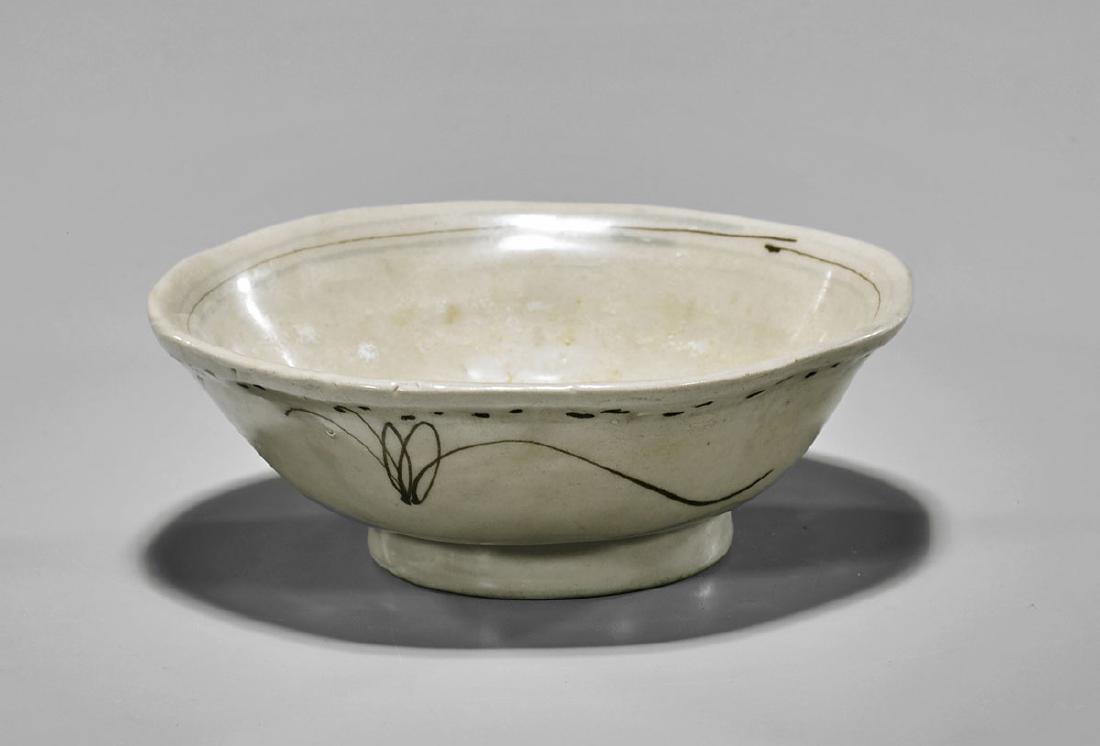 Ming Dynasty Glazed Porcelain Bowl: Antique Chinese porcelain bowl; of footed, somewhat lobed form with brown and pink glazed floral sprays; ringed by underglaze blue borders; likely produced for the Vietnamese market; late Ming Dynasty