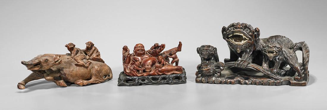 Three Chinese Carved Wood Groups: Three Chinese carved wood groups, including: reclining Buddha in playful interaction with five boys; detailed Fo lions and young in attentive stance on large flower merging into base; together with wa