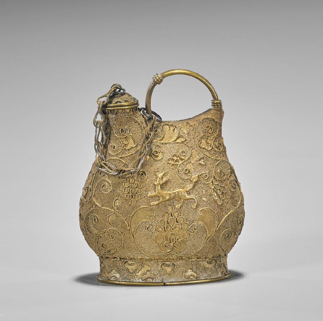 Liao-Style Gilt Filigree Vessel: Chinese Liao-style gilt filigree yellow metal flask vessel; with creatures in relief amid intricate scrolling floral designs; H: 3 5/8"