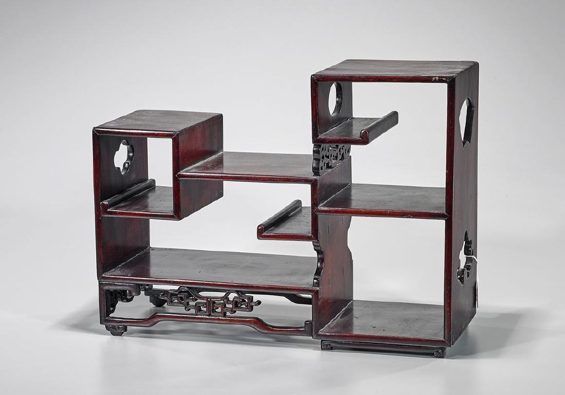 Chinese Carved Hardwood Tiered Curio Cabinet: Chinese carved hardwood curio cabinet; with tiered compartments for display; showing scrolling openwork and pierced designs to base and sides; 13 3/4" x 18 1/2" x 7" (approx.)