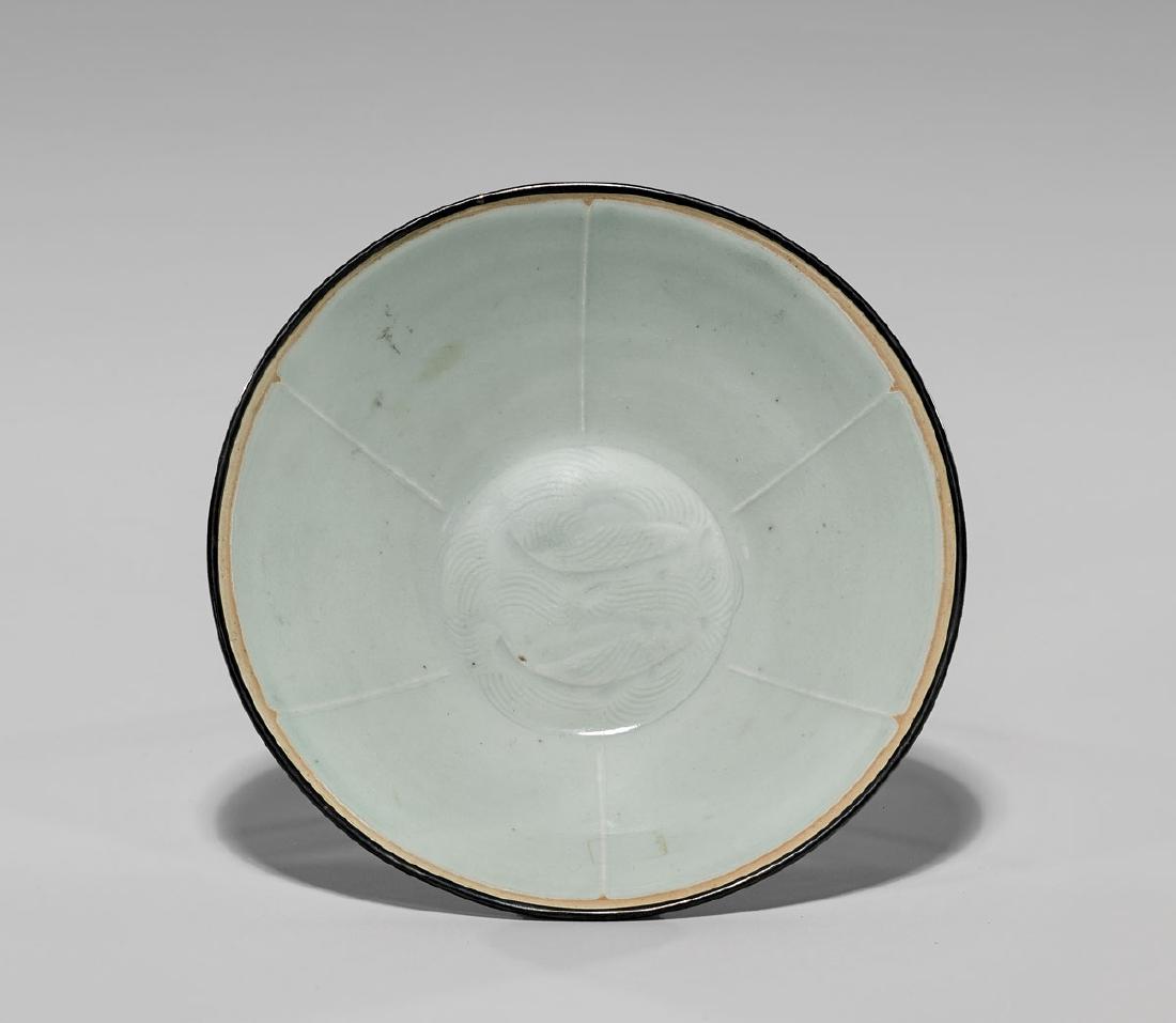 Song Dynasty 'Double Fish' Bowl: Antique Chinese Song Dynasty qingbai glazed bowl; of subtly rounded conical form, set upon a short foot; the interior showing incised design of two fish amid combed wave patterning; encircled by six l