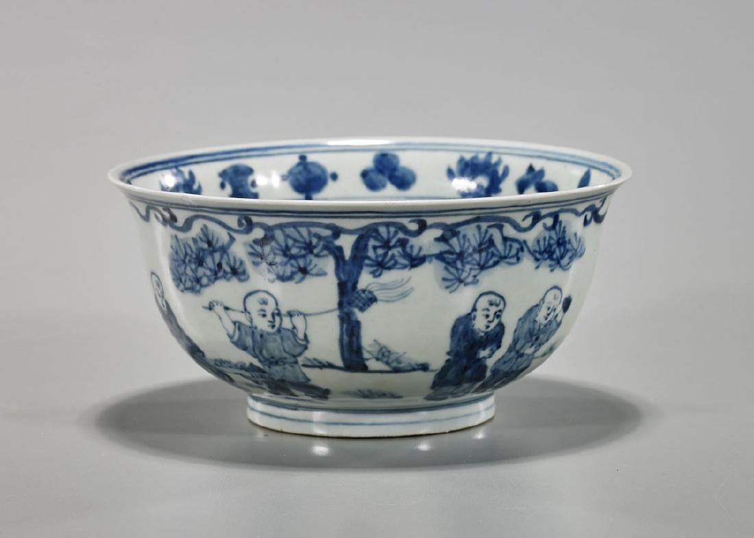Ming-Style Blue & White Porcelain Bowl: Chinese Ming-style blue and white porcelain bowl; of simple circular form with stepped base and slight flare to rim; showing continuous figural scene of young boys at play to exterior, and Buddhist em