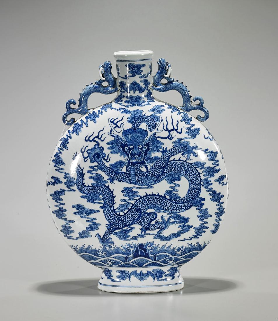 Qianlong-Style Blue & White Porcelain Moonflask: Chinese Qianlong-style blue and white porcelain moonflask; exhibiting elaborate dragon designs to face and verso; with moulded dragon handles to shoulders and seal mark to base; Provenance: Collection