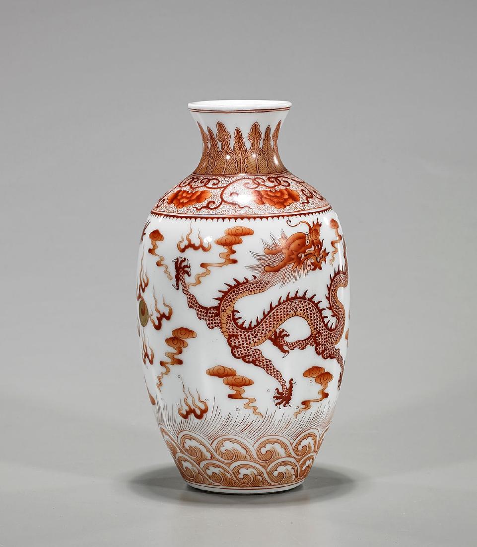 Chinese Coral Red Porcelain Dragon Vase: Chinese coral red porcelain dragon vase; of ovoid form with flared rim; showing well-detailed designs of scrolling dragons amid stylized clouds and flaming pearls; Guangxu mark to base, but later; H: 