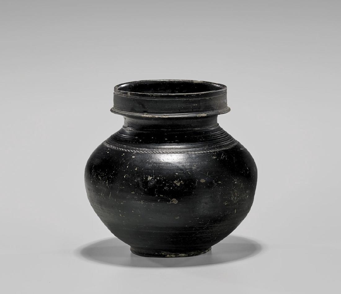 ANTIQUE CHINESE BLACKWARE POTTERY JAR: Antique Chinese blackware pottery jar; the globular body surmounted by a tall, cylindrical lip; the shoulder showing concentric bands above an incised border; Han Dynasty or earlier; D: 7" (ap