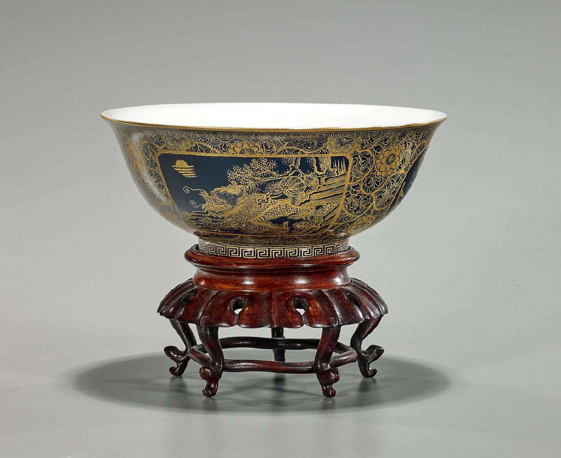 Chinese Gilt Porcelain Bowl: Chinese gilt porcelain bowl; of wide circular form with raised base; exhibiting gilt flora, dragon and butterfly motifs atop a cobalt blue ground; with double concentric mark to base; D: 8" (a