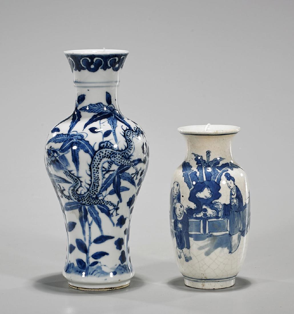 Two Antique Chinese Blue & White Porcelain Vases: Two antique Chinese blue and white porcelain vases, including: tapered form with flared rim, exhibiting scrolling dragons amid various fauna, with four-character Kanxi mark to base, but later; togethe