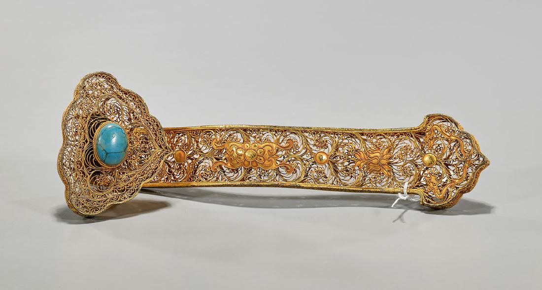 Liao-Style Gilt Metal Ruyi Scepter: Chinese Liao-style gilt metal ruyi scepter; comprised of fine filigree, exhibiting lotus flowers and dragons amid scrolling designs; featuring inset cabochon to top of teal-green coloration; L: 11"