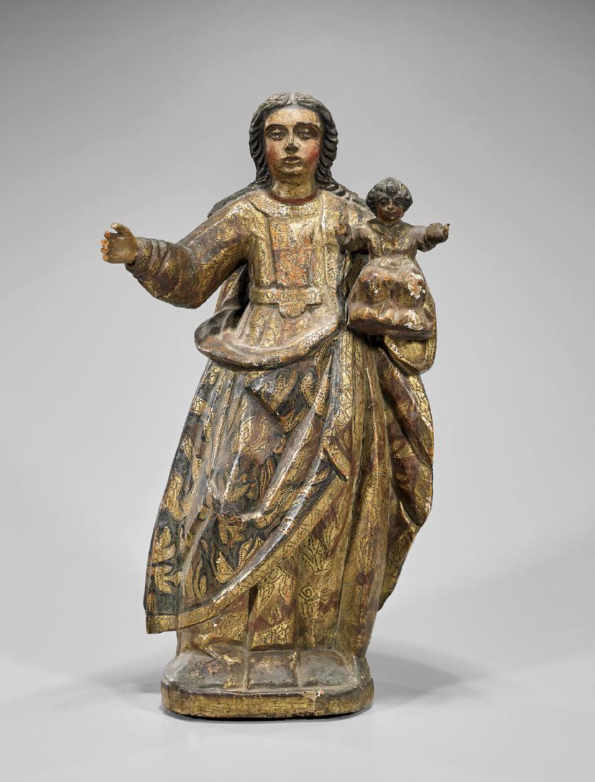 SPANISH COLONIAL POLYCHROME WOOD GROUP: Madonna & Child: Antique Spanish Colonial parcel-gilt and polychrome wood group; of the Madonna draped in well-detailed robes, her right arm extended and her left holding the Christ child; his arms extended in gesture