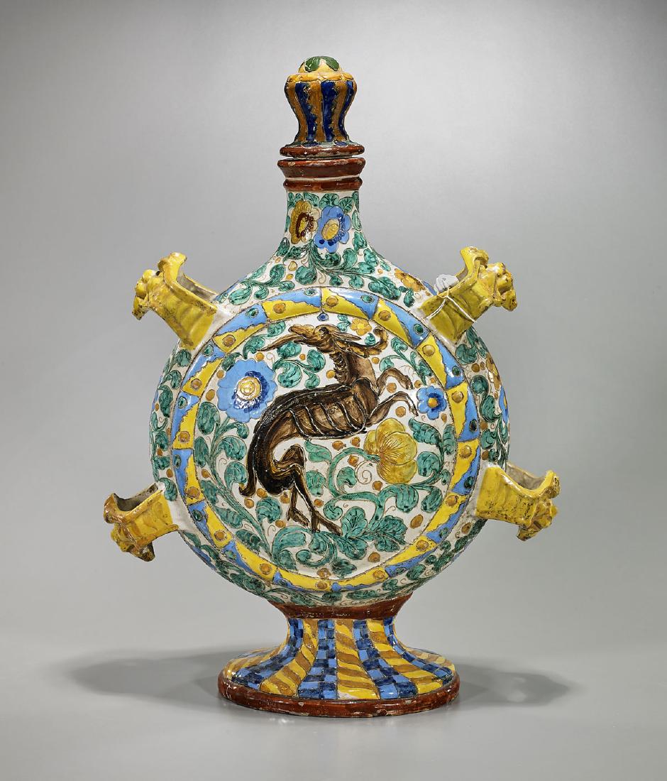 Italian Majolica Earthenware Flask: Italian majolica earthenware flask; with four moulded mask handles; exhibiting central design of a peacock on a dense foliate ground to face; with four legged beast to verso; Provenance: Collection of