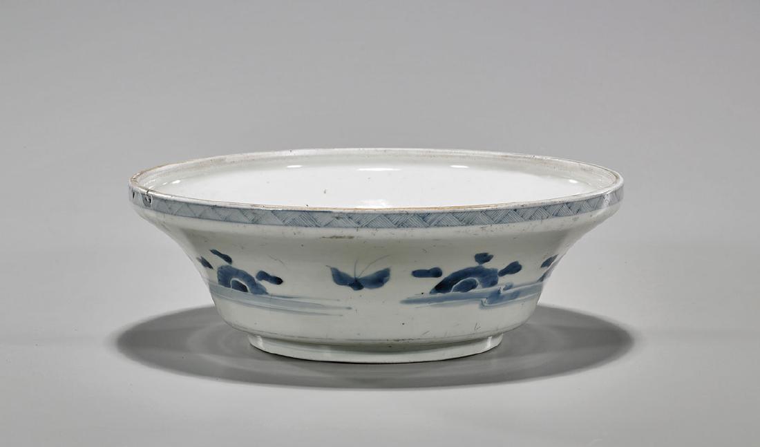 Antique Chinese Blue & White Porcelain Basin: Antique Chinese blue and white porcelain basin; of wide circular form, with raised rim and stepped base; showing simple flora and fauna motifs to exterior, with linear patterning to rim; D: 10 1/4"