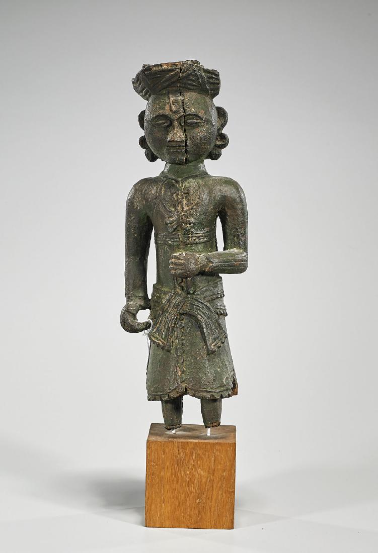 Antique Indonesian Polychrome Wood Figure: Antique Indonesian polychrome wood figure; standing, with hands gesturing; wearing long robe and hat; the round face showing incised facial and forehead features; mounted atop a square base; H: 15"