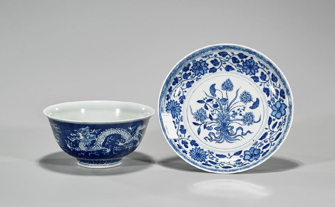 Two Chinese Blue & White Porcelain Pieces: Two Chinese blue and white porcelain pieces, including: bowl, showing continuous pattern of dragons chasing flaming pearl, Kangxi mark to base, but later; together with dish, featuring scrolling folia