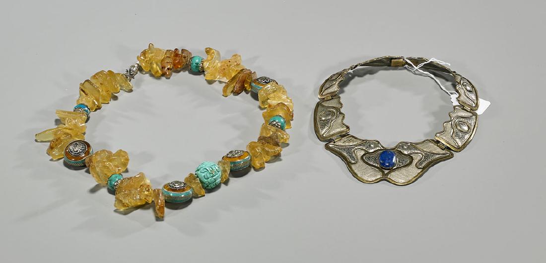 Two Various Stone & Metal Necklaces: Two various stone & metal necklaces: one centering a lapis lazuli cabochon, the verso reading Artesania Ameri / Chile; together with amber, each of irregular forms, interspersed with turquoise beads; 