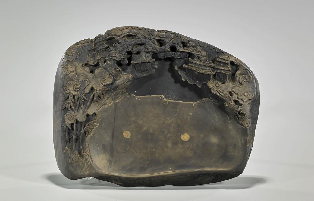 Chinese Carved Inkstone: Chinese carved inkstone; the stone showing architectural landscape scene amid stylized clouds, birds and trees; L: 11 1/2" approx.