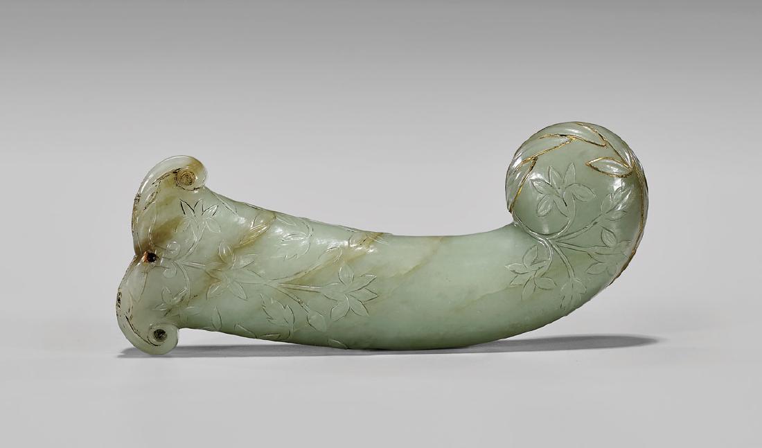 18TH CENTURY MUGHAL JADE DAGGER HILT: Mughal carved celadon jade dagger hilt; of pistol-grip form, exquisitely carved with foliate sprays in light relief; and with some gilt inlay remaining; 18th Century; L: 5 1/4" PROVENANCE Estate o