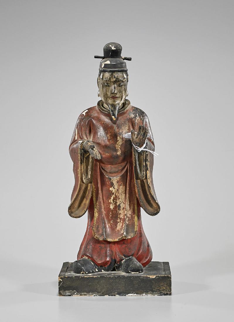 Antique Chinese Ming Dynasty Lacquered Wood Figure: Antique Chinese Ming Dynasty lacquered wood figure; wearing long red robe, showing scrolling flora and fauna designs; hands gesturing, and standing atop a rectangular base; Provenance: Private collect