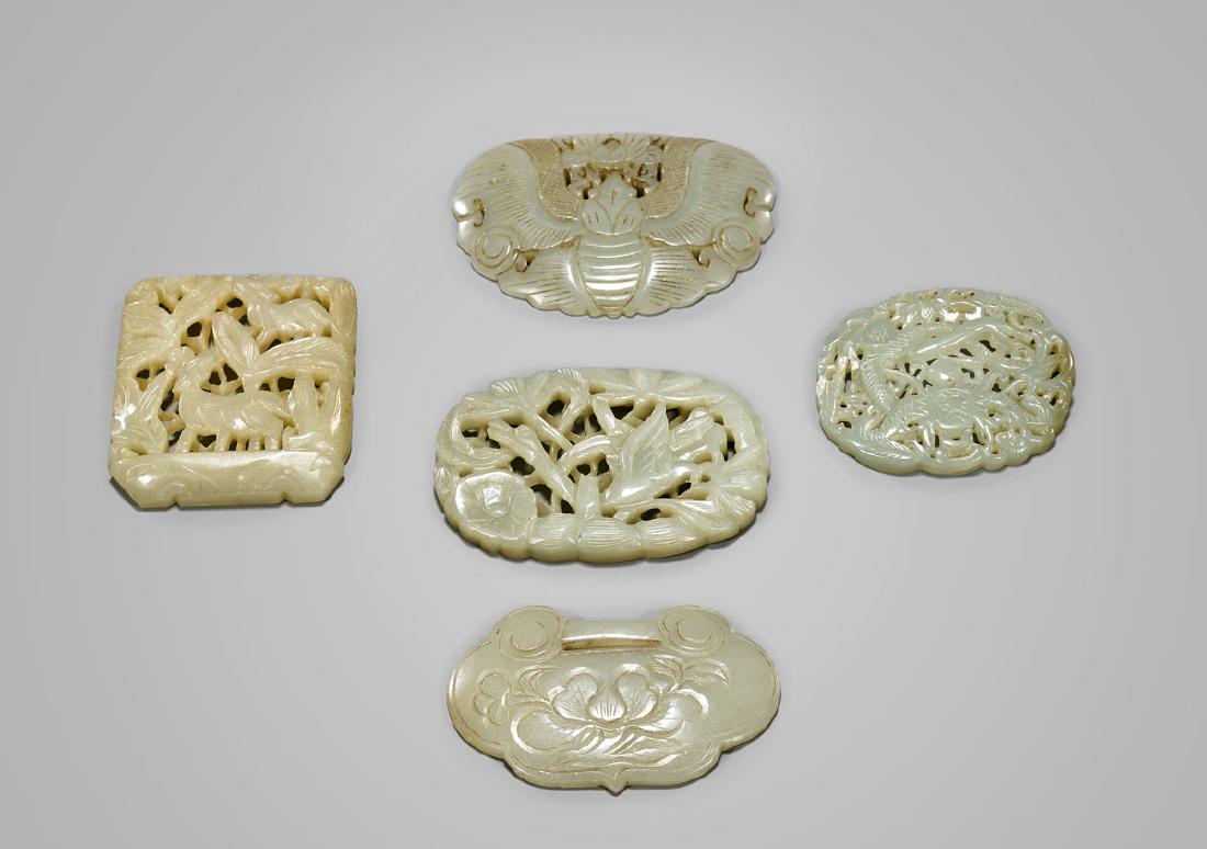FIVE CARVED CELADON JADE PLAQUES (1 of 2)