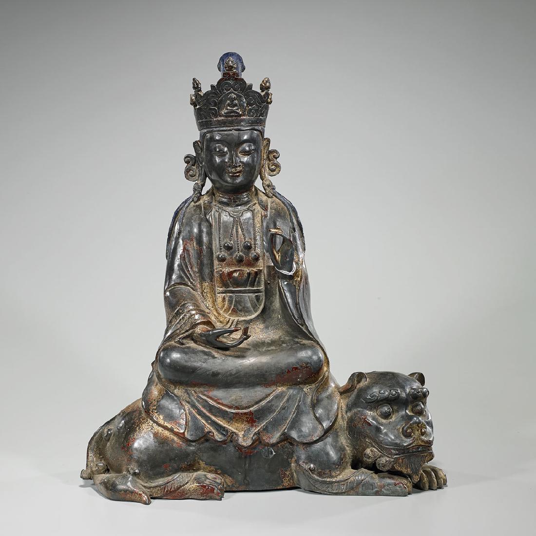Large Chinese Parcel-Gilt Bronze Seated Guanyin: Large Chinese parcel-gilt bronze Guanyin; wearing ornate garlands and crown; eyes downcast, with hands gesturing; seated atop a lotus base; upon a recumbent lion; H: 23 1/2" (approx.)