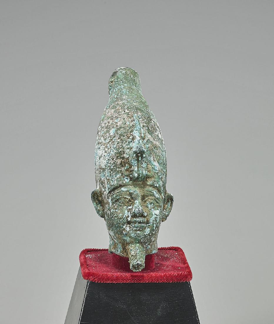 Egyptian Bronze Head of a Pharaoh: Egyptian bronze head of a Pharaoh after the ancient; wearing the Hedjet crown of Upper Egypt, and a false beard; set atop a tiered trapezoidal base, enclosed in lucite case; Provenance: Collection of 