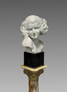 MARBLE BUST BY MAXIME REAL DEL SARTE: La Faunesse: Marble bust by Maxime Real del Sarte (French, 1888-1954), titled La Faunesse; signed to shoulder; mounted on stone plinth and further set upon an ormolu-mounted onyx columnar pedestal; H: 13&#