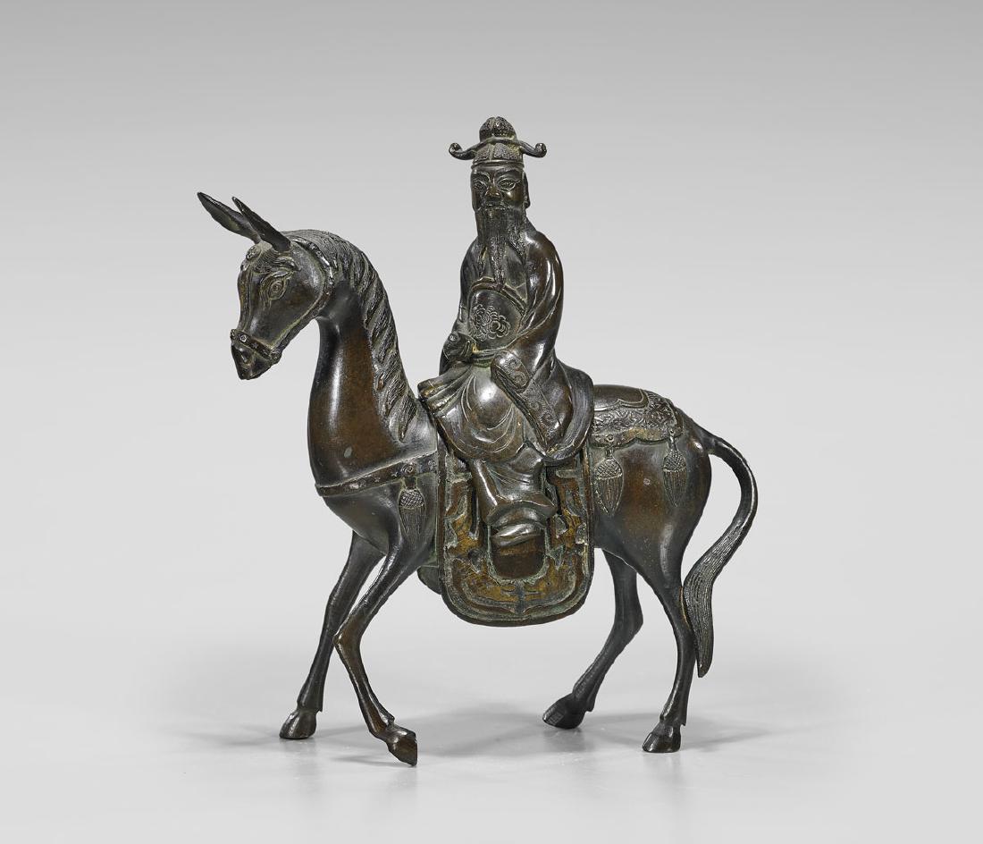 BRONZE FIGURAL CENSER: Scholar & Donkey: Chinese bronze figural censer; in the form of a scholar riding atop a donkey; late 19th Century; H: 9"
