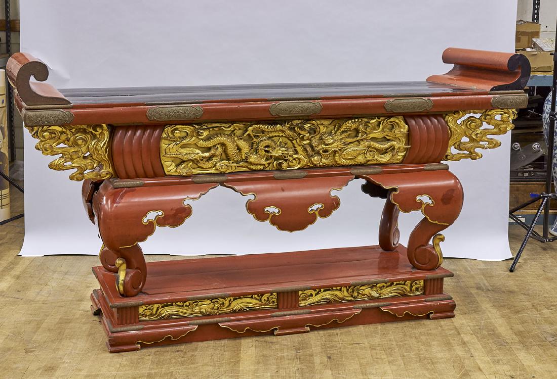 Large Japanese Gilt & Lacquered Wood Altar Table: Large Japanese gilt and lacquered wood altar table; showing elaborate dragons chasing flaming pearl in relief to apron; inscriptions to one leg; Provenance: Private collection, Beverly Hills; 46" 