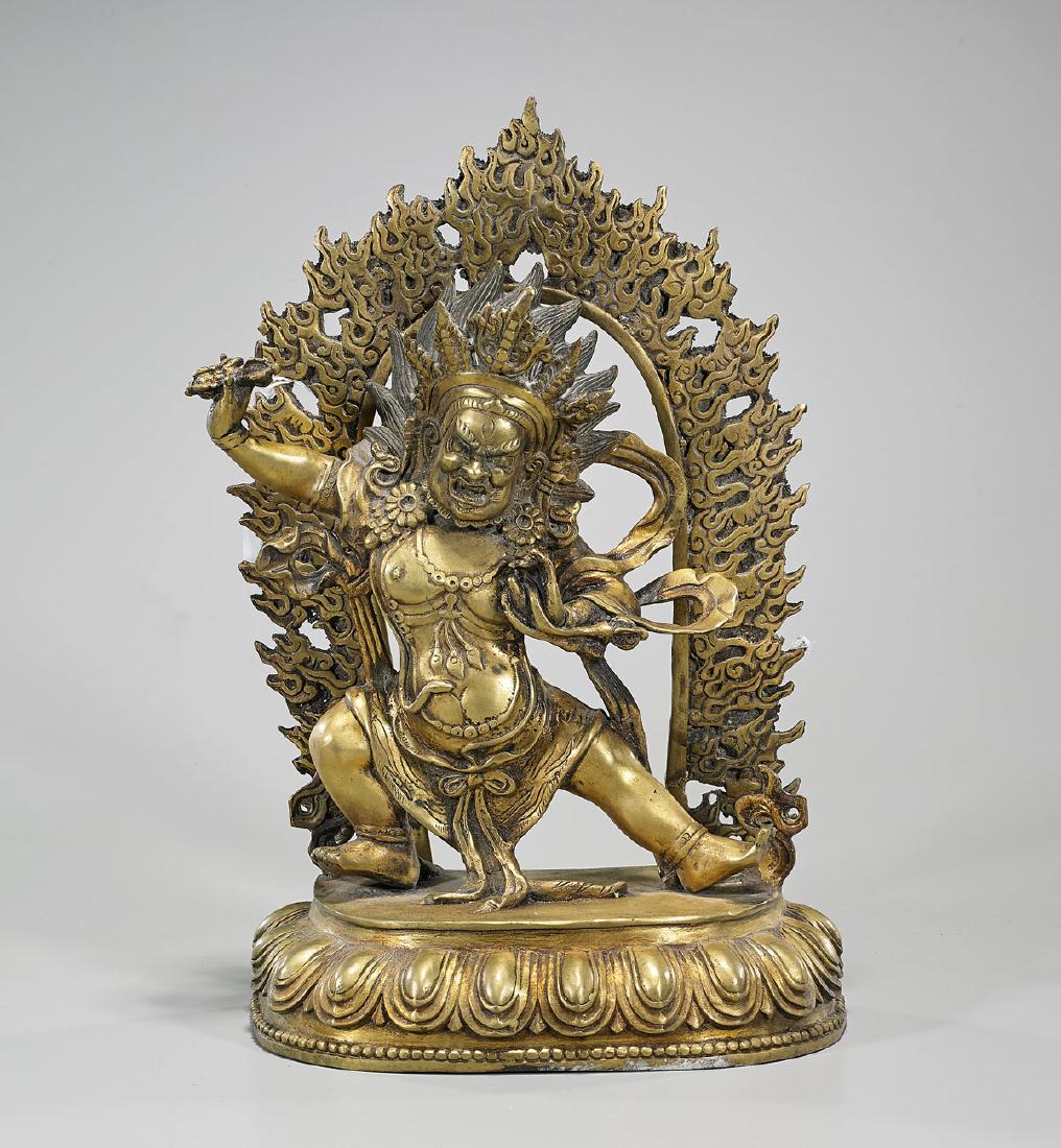 Chinese Gilt Bronze Standing Deity: Chinese parcel-gilt bronze of a wrathful deity; set before a sectional flaming mandorla; all atop a lotus base; six-character mark to verso; H: 14 1/2" (approx.)