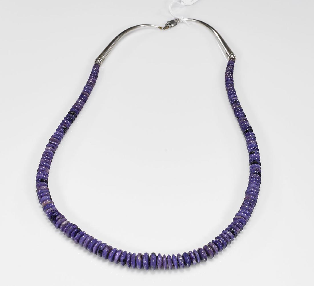 Stone Bead Necklace: Stone bead necklace; comprising of graduating discs forms, possibly charoite; with sterling silver clasp stamped 925; Provenance: Estate of Randy Melson; L: 31 1/2" (approx.)